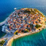 Primosten town, Croatia. View of the city from the air. Seascape with beach and old town.