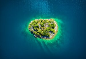 Island in the sea in Croatia. Aerial view on island with forest. Adriatic sea, Croatia.